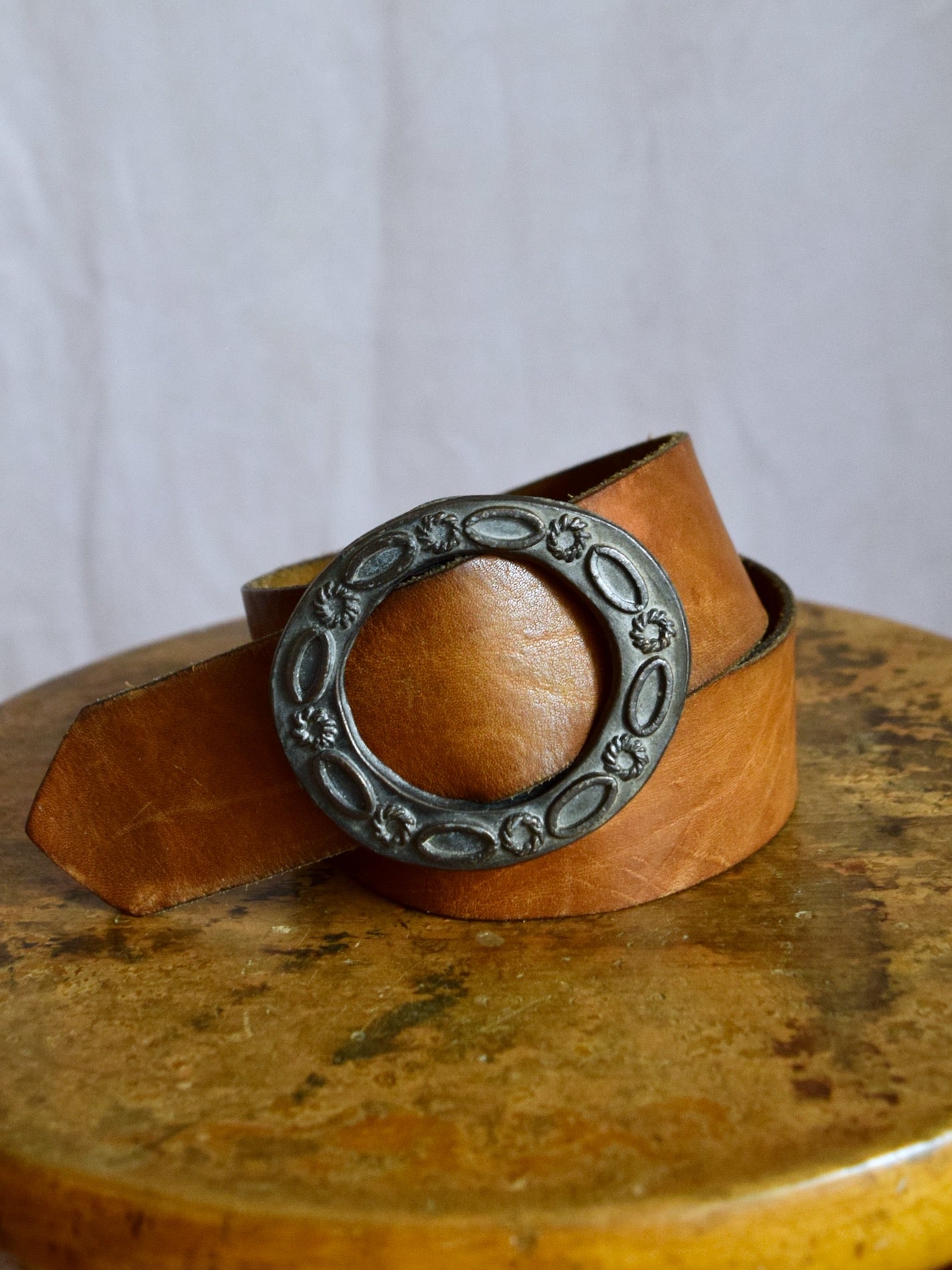 vintage 1970s medium brown leather belt with cast metal buckle